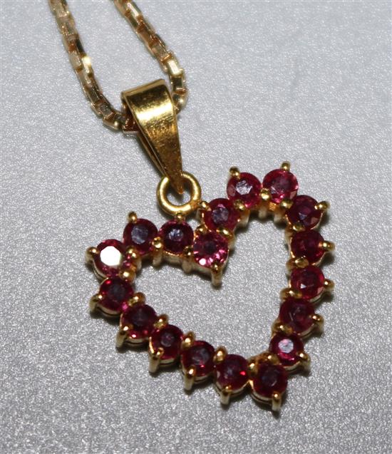 An 18ct gold and ruby open heart shaped pendant on an 18ct gold box link chain, chain 15in.